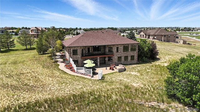 31200 E 145th Ave, Brighton, CO 80603 - rear view of house featuring a patio area, a balcony, a residential view, and a yard