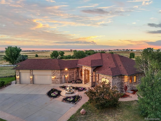31200 E 145th Ave, Brighton, CO 80603 - view of front of property with stone siding, driveway, and a garage