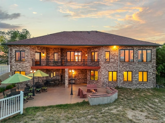 31200 E 145th Ave, Brighton, CO 80603 - rear view of property featuring a patio area, a shingled roof, a yard, and a balcony