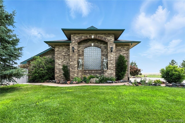 31200 E 145th Ave, Brighton, CO 80603 - view of front of home with brick siding and a front yard