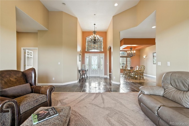 31200 E 145th Ave, Brighton, CO 80603 - living room with a chandelier, healthy amount of natural light, a towering ceiling, dark tile patterned floors, and recessed lighting