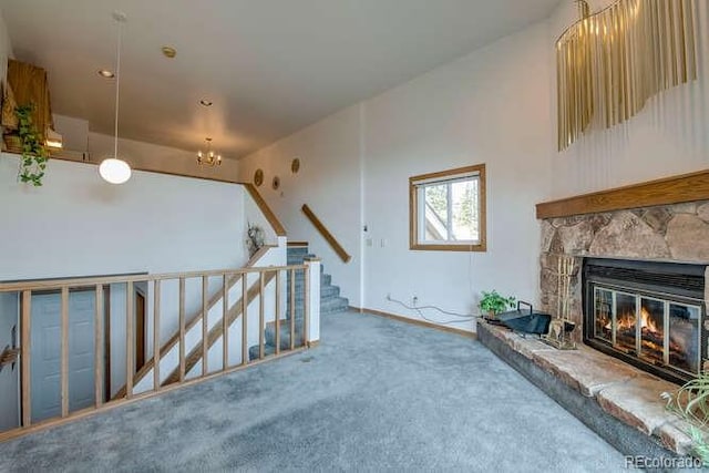 unfurnished living room featuring carpet flooring and a stone fireplace