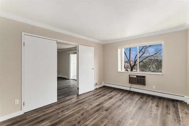 spare room featuring crown molding, baseboard heating, baseboards, a baseboard heating unit, and dark wood-type flooring