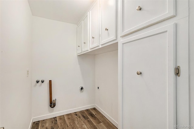 clothes washing area with baseboards, cabinet space, wood finished floors, and hookup for an electric dryer