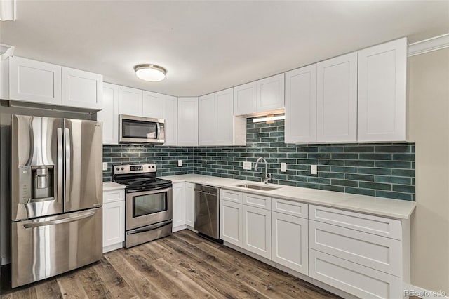 3460 S Poplar St Unit 404, Denver, CO 80224 - kitchen featuring appliances with stainless steel finishes, a sink, light countertops, and white cabinetry