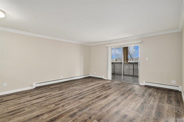 3460 S Poplar St Unit 404, Denver, CO 80224 - spare room featuring baseboard heating, crown molding, a baseboard heating unit, wood finished floors, and baseboards