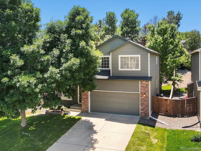 2548 Foothills Canyon Ct, Highlands Ranch, CO 80129 - view of front facade with brick siding, an attached garage, and driveway