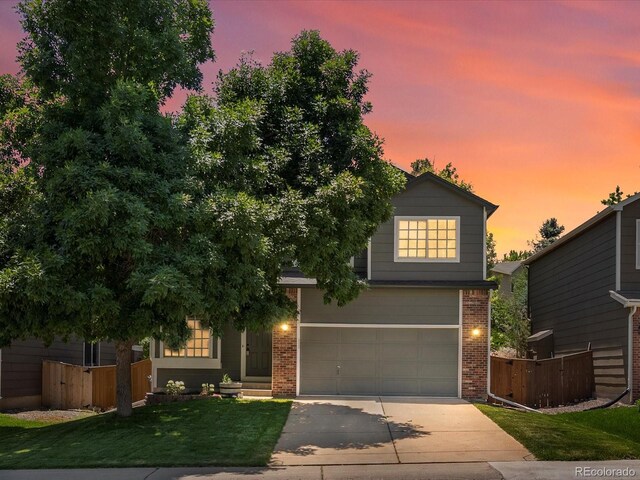 2548 Foothills Canyon Ct, Highlands Ranch, CO 80129 - view of front of property with brick siding, concrete driveway, and an attached garage