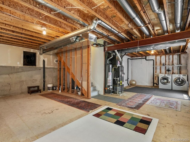 2548 Foothills Canyon Ct, Highlands Ranch, CO 80129 - unfinished basement featuring independent washer and dryer, stairs, and water heater