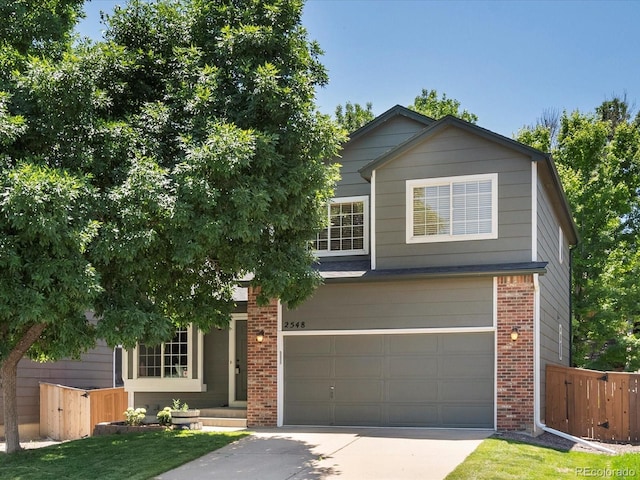 2548 Foothills Canyon Ct, Highlands Ranch, CO 80129 - view of front of property with a garage, brick siding, and concrete driveway