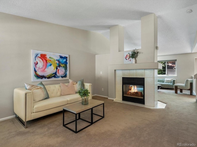 2548 Foothills Canyon Ct, Highlands Ranch, CO 80129 - living area featuring carpet floors, a textured ceiling, a fireplace, and vaulted ceiling