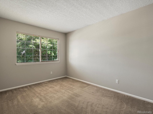 2548 Foothills Canyon Ct, Highlands Ranch, CO 80129 - carpeted spare room featuring baseboards and a textured ceiling