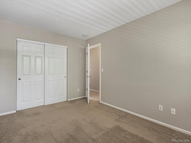 2548 Foothills Canyon Ct, Highlands Ranch, CO 80129 - unfurnished bedroom featuring carpet, a closet, and a textured ceiling