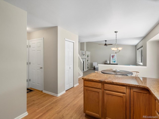 2548 Foothills Canyon Ct, Highlands Ranch, CO 80129 - kitchen with brown cabinets, light wood-type flooring, pendant lighting, and ceiling fan