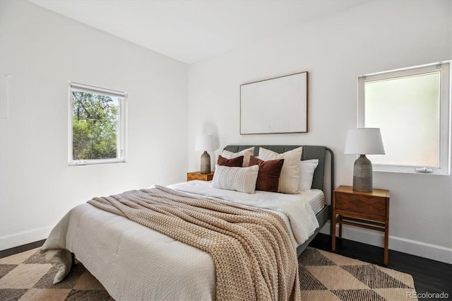 bedroom with baseboards and wood finished floors