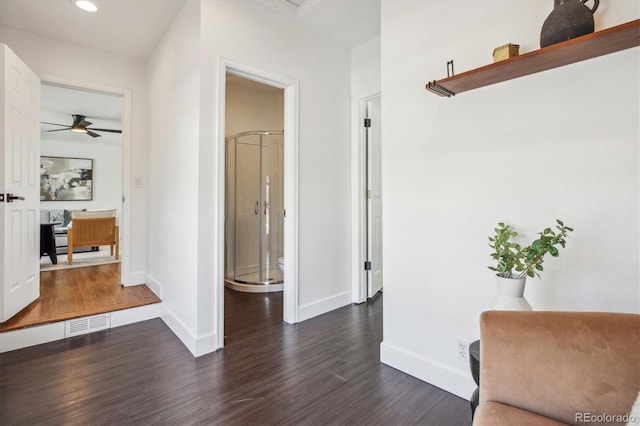 hall with dark wood finished floors, baseboards, and recessed lighting