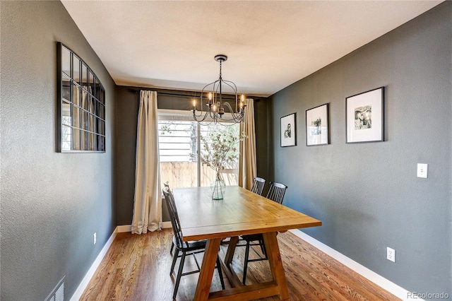 5397 S Killarney St, Centennial, CO 80015 - dining space with a chandelier, a textured wall, and wood finished floors