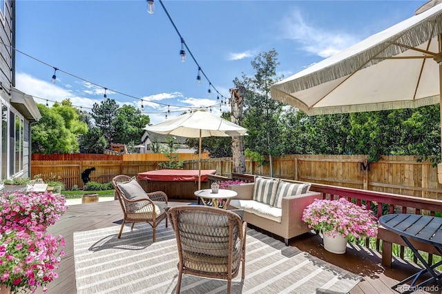 5397 S Killarney St, Centennial, CO 80015 - deck featuring a hot tub, a fenced backyard, and an outdoor living space