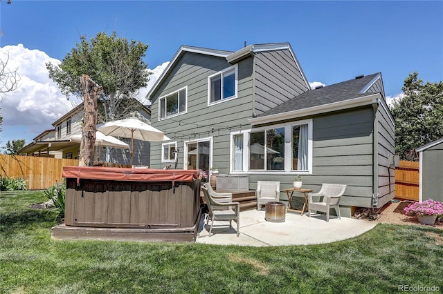 5397 S Killarney St, Centennial, CO 80015 - rear view of property featuring a hot tub, a patio, and roof with shingles