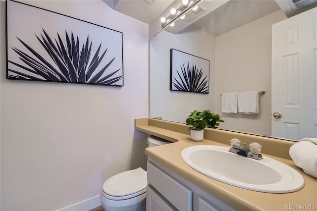 bathroom featuring vanity and toilet