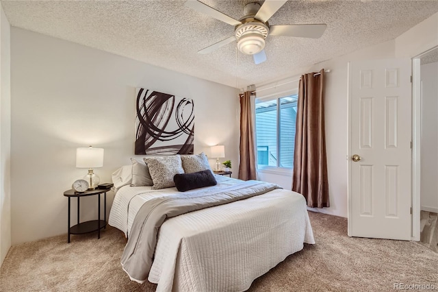 carpeted bedroom with a textured ceiling and ceiling fan