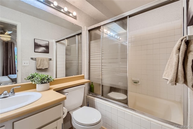 full bathroom with a textured ceiling, vanity, toilet, and bath / shower combo with glass door