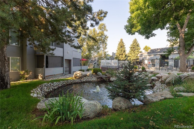 view of home's community featuring a small pond