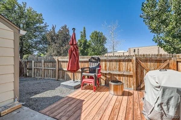 deck featuring a fenced backyard and a grill