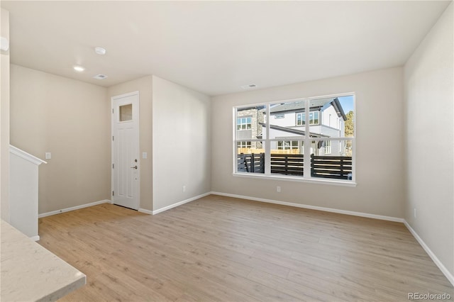 spare room with light hardwood / wood-style floors