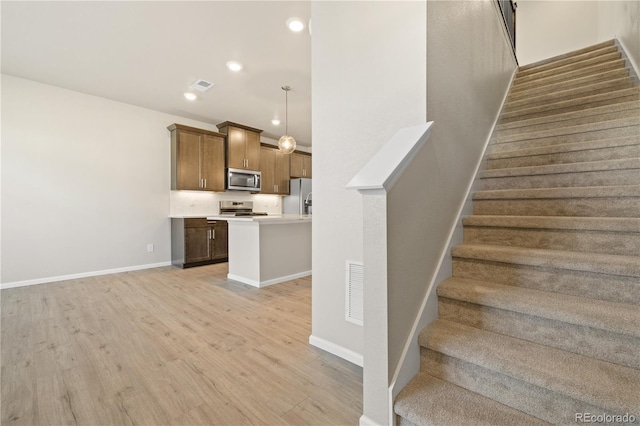 stairs featuring hardwood / wood-style flooring