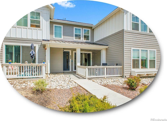 7488 W Pacific Ln, Denver, CO 80227 - view of front facade featuring covered porch, board and batten siding, a standing seam roof, and a metal roof