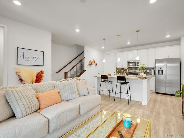7488 W Pacific Ln, Denver, CO 80227 - living room with recessed lighting, light wood-type flooring, and stairway