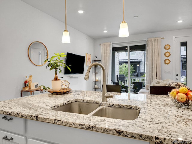 7488 W Pacific Ln, Denver, CO 80227 - kitchen with light stone counters, open floor plan, pendant lighting, and recessed lighting