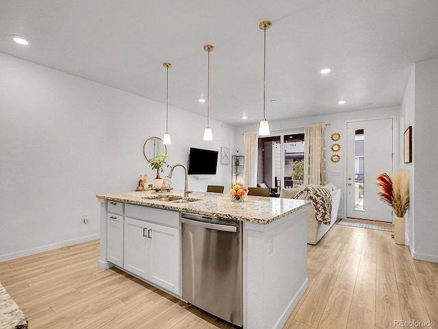 7488 W Pacific Ln, Denver, CO 80227 - kitchen with stainless steel dishwasher, open floor plan, light wood-type flooring, light stone counters, and recessed lighting