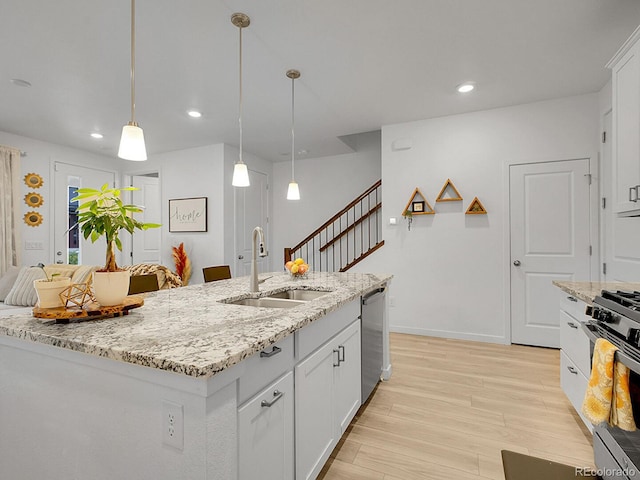7488 W Pacific Ln, Denver, CO 80227 - kitchen with appliances with stainless steel finishes, light wood-type flooring, recessed lighting, white cabinetry, and hanging light fixtures