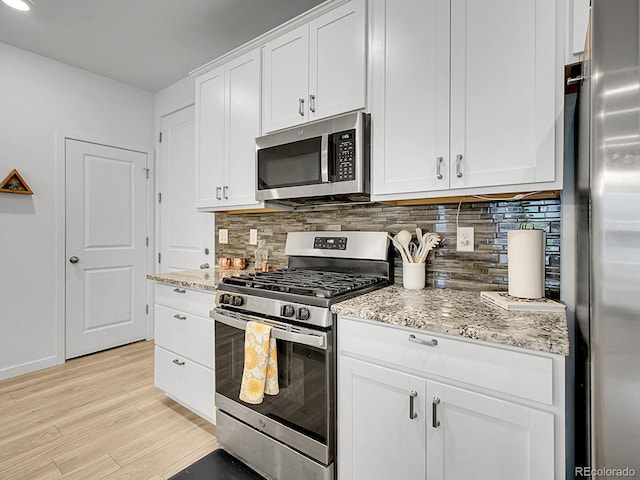 7488 W Pacific Ln, Denver, CO 80227 - kitchen featuring appliances with stainless steel finishes, backsplash, light wood-style floors, light stone countertops, and recessed lighting
