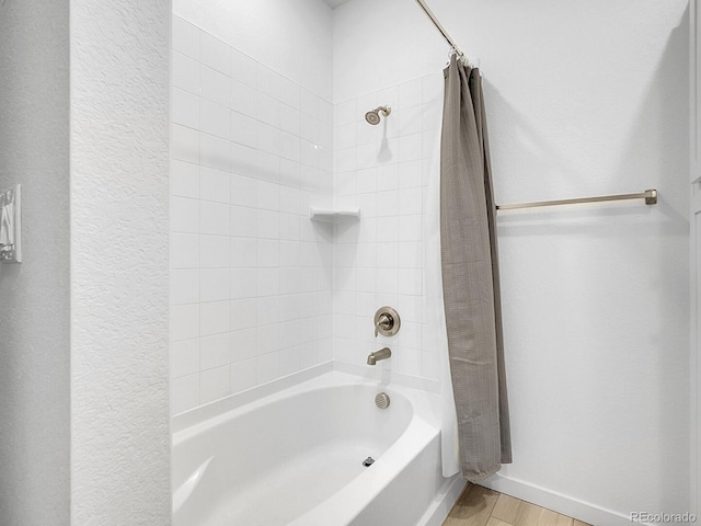 7488 W Pacific Ln, Denver, CO 80227 - bathroom with shower / tub combo with curtain and wood finished floors
