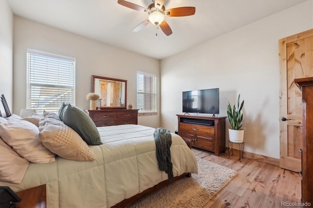 bedroom with light hardwood / wood-style flooring and ceiling fan