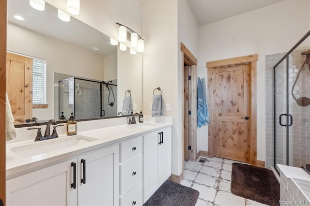 bathroom featuring vanity and a shower with shower door