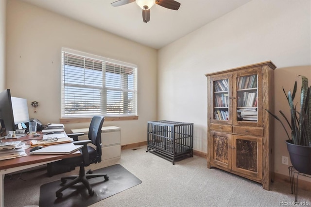 home office with light carpet and ceiling fan