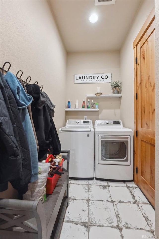 washroom featuring washing machine and clothes dryer