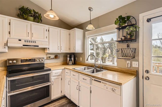 kitchen featuring range with two ovens, dishwasher, a sink, lofted ceiling, and under cabinet range hood