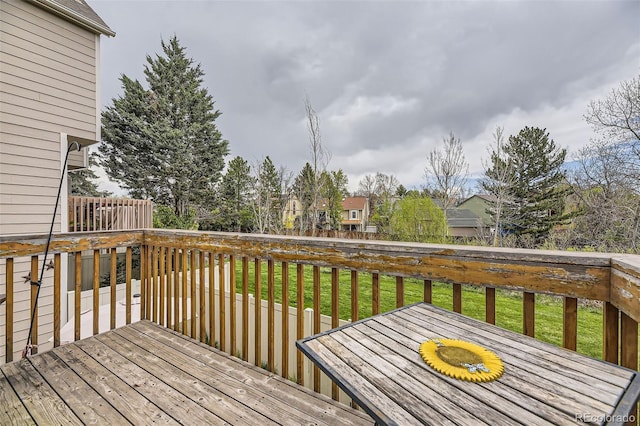 wooden terrace featuring a yard