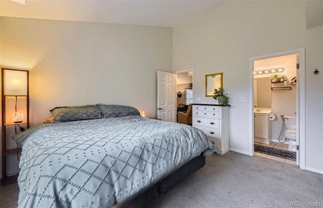 carpeted bedroom with baseboards, tile patterned flooring, and vaulted ceiling
