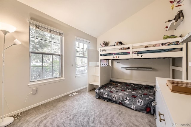 carpeted bedroom with baseboards, vaulted ceiling, and visible vents