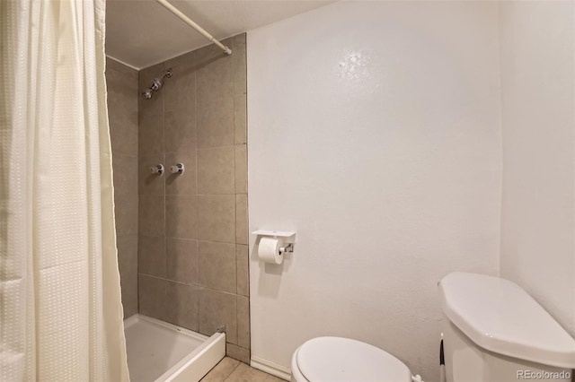full bath with tile patterned floors, baseboards, a stall shower, and toilet