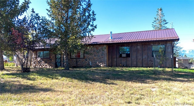 rear view of house featuring a lawn