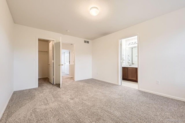 1998 Coach House Loop, Castle Rock, CO 80109 - unfurnished bedroom with light carpet, a walk in closet, a closet, and ensuite bathroom