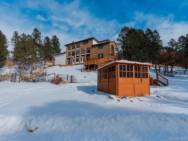 snow covered property featuring a deck