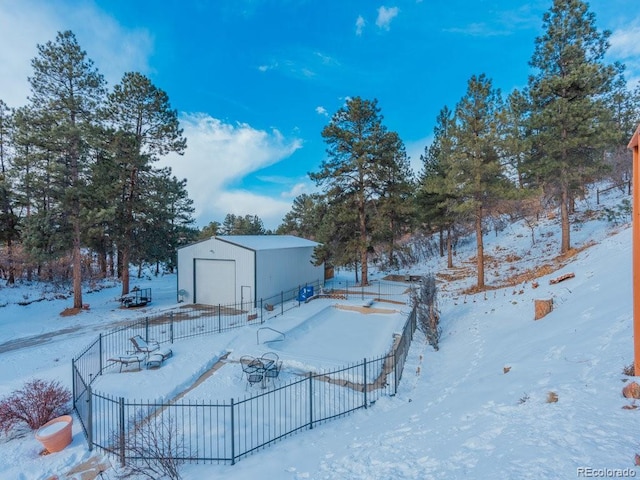 yard layered in snow featuring an outbuilding